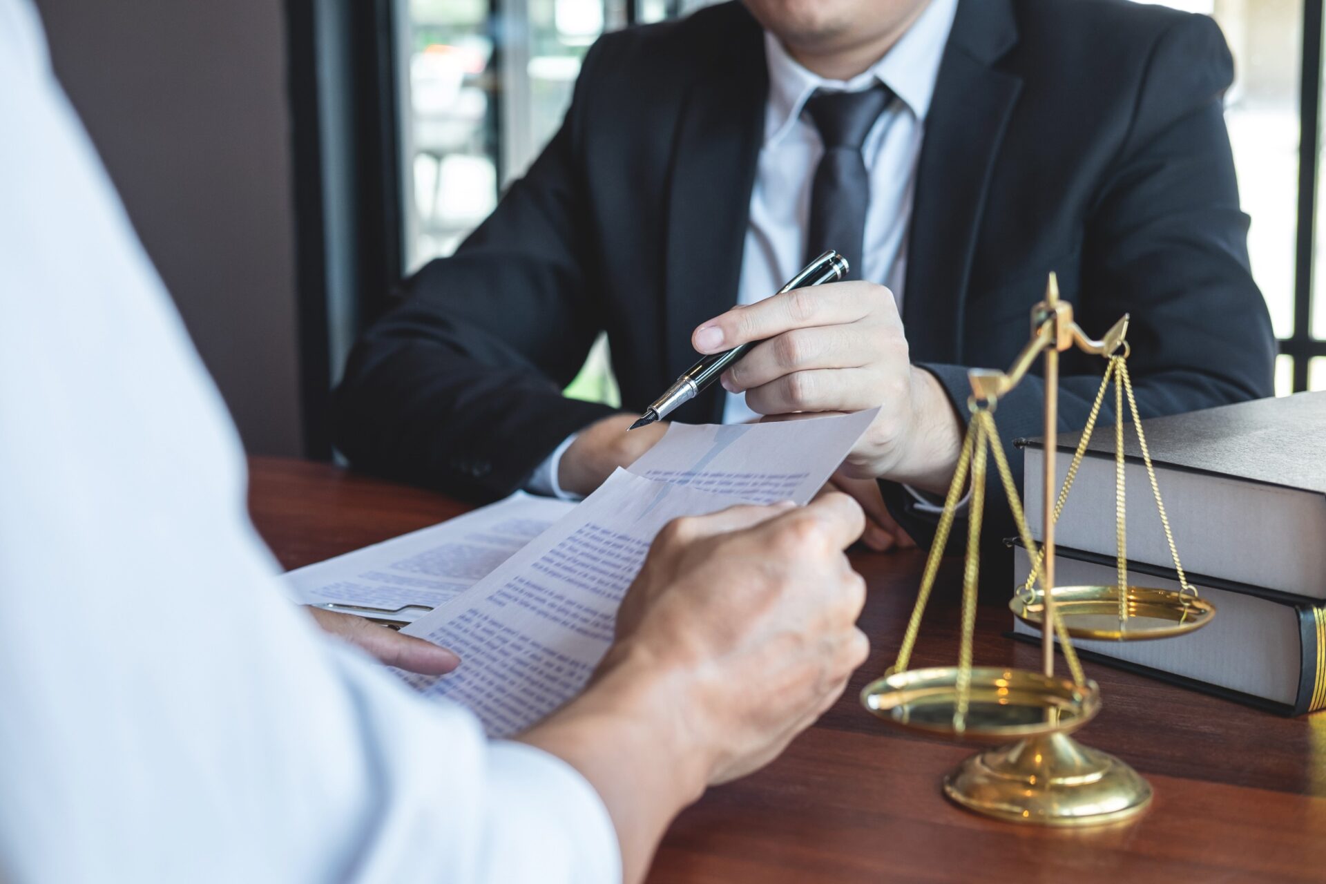 Male lawyer discussing negotiation legal case with client meeting with document contact in courtroom law and justice concept